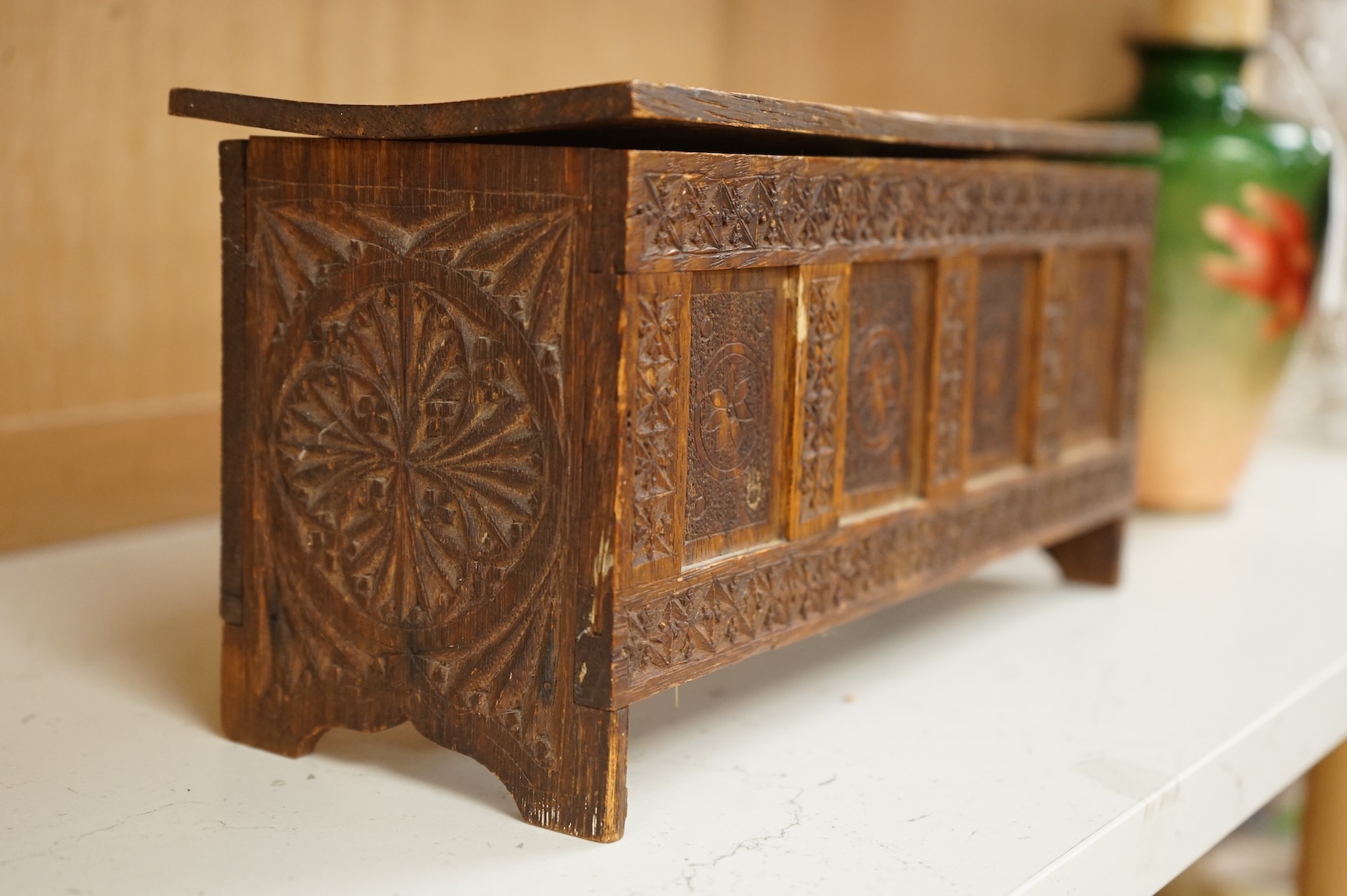 A chip-carved oak miniature coffer with incised date 1901 to the interior, 28cm wide